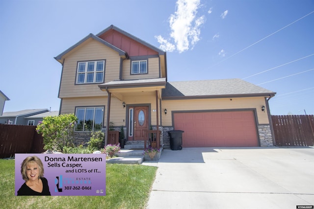 810 S 3rd Ave, Mills, WY 82604 - view of front facade featuring stone siding, an attached garage, and driveway