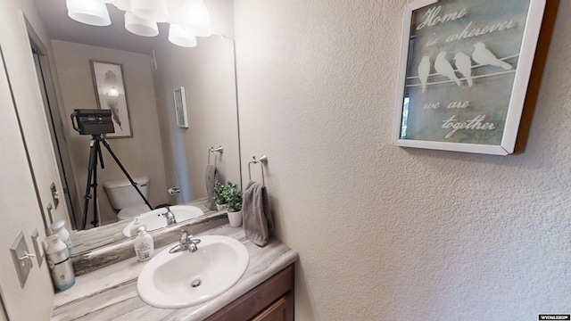 810 S 3rd Ave, Mills, WY 82604 - half bathroom featuring toilet, vanity, and a textured wall