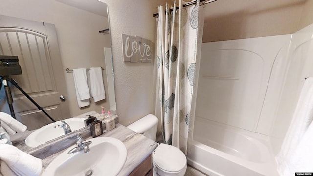 810 S 3rd Ave, Mills, WY 82604 - full bath with shower / bath combination with curtain, toilet, a textured wall, and vanity