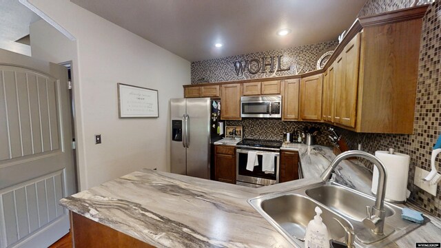 810 S 3rd Ave, Mills, WY 82604 - kitchen with stainless steel appliances, a sink, tasteful backsplash, a peninsula, and recessed lighting
