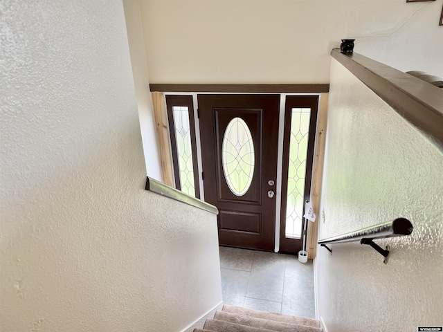 1130 Canyon Rd, Kemmerer, WY 83101 - foyer with a textured wall, tile patterned floors, stairs, and healthy amount of natural light