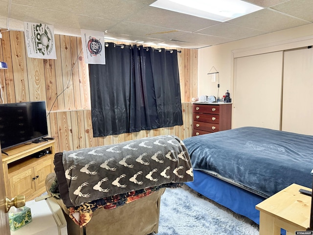 1130 Canyon Rd, Kemmerer, WY 83101 - bedroom with wooden walls, a paneled ceiling, and a closet