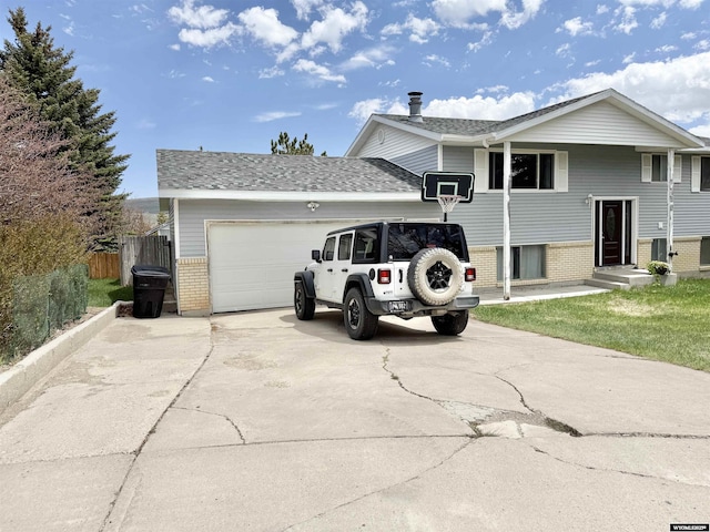 1130 Canyon Rd, Kemmerer, WY 83101 - view of front of house with brick siding, a garage, and concrete driveway
