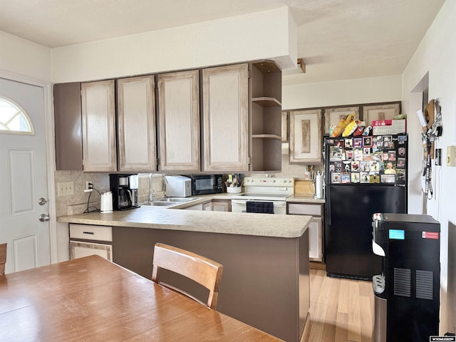 1130 Canyon Rd, Kemmerer, WY 83101 - kitchen with black appliances, a sink, open shelves, and backsplash