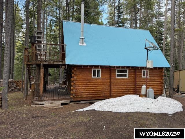 1725 E End Rd, Casper, WY 82601 - view of home's exterior with log exterior, a deck, metal roof, and stairs