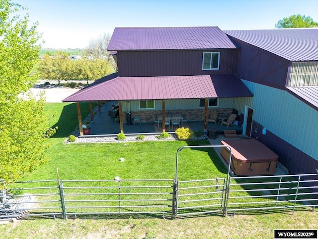 200 Irwin Ln, Lander, WY 82520 - back of property with a hot tub, a patio, stone siding, and metal roof