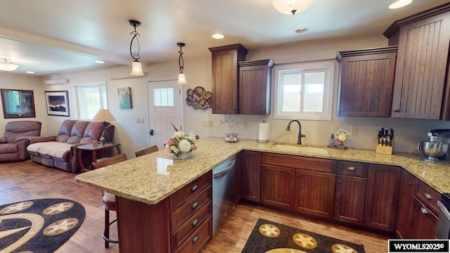 200 Irwin Ln, Lander, WY 82520 - kitchen featuring a sink, stainless steel dishwasher, a breakfast bar area, a peninsula, and light wood-style flooring