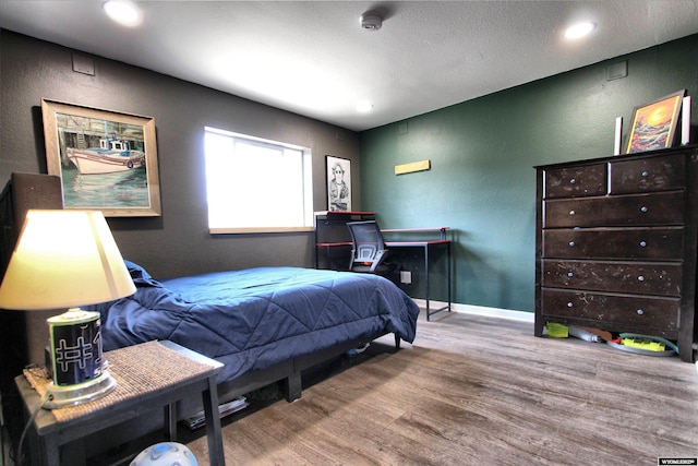 6653 Natrona Rd, Natrona, WY 82646 - bedroom with wood finished floors, a textured wall, recessed lighting, and baseboards