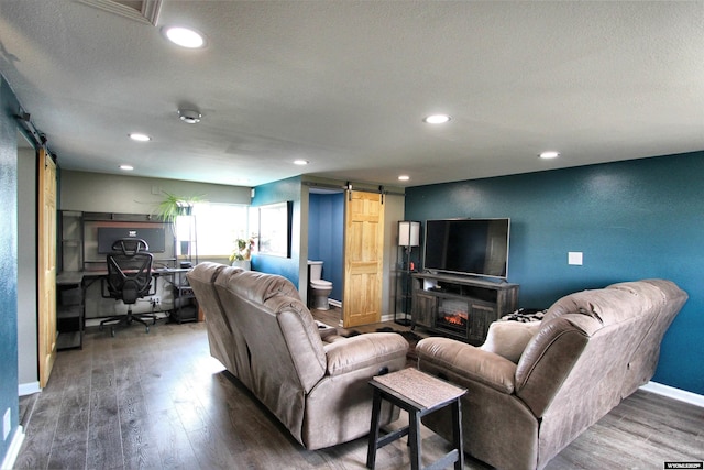 6653 Natrona Rd, Natrona, WY 82646 - living room with a barn door, an office area, wood finished floors, recessed lighting, and baseboards