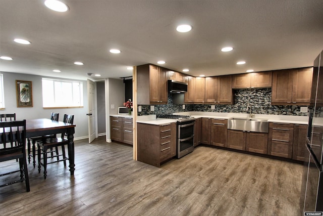 6653 Natrona Rd, Natrona, WY 82646 - kitchen with double oven range, a sink, light countertops, backsplash, and recessed lighting