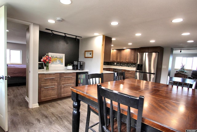6653 Natrona Rd, Natrona, WY 82646 - dining room with rail lighting, wine cooler, light wood-type flooring, and recessed lighting