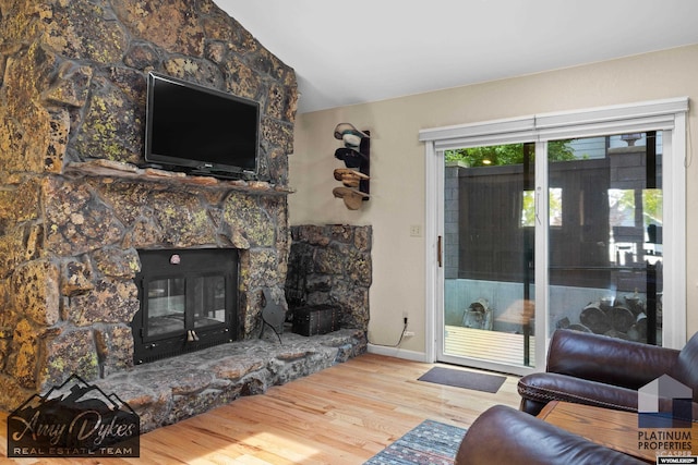 1131 W 60th St, Casper, WY 82601 - living room with wood finished floors, a fireplace, and baseboards
