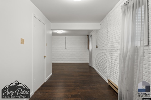 1131 W 60th St, Casper, WY 82601 - corridor featuring brick wall, a baseboard heating unit, and wood finished floors