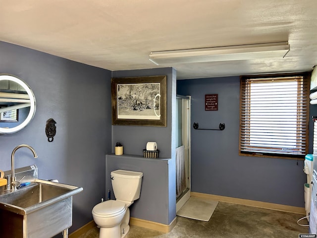 2609 Beaver Creek Rd, Shell, WY 82441 - full bath featuring a sink, toilet, a shower with shower curtain, baseboards, and concrete flooring
