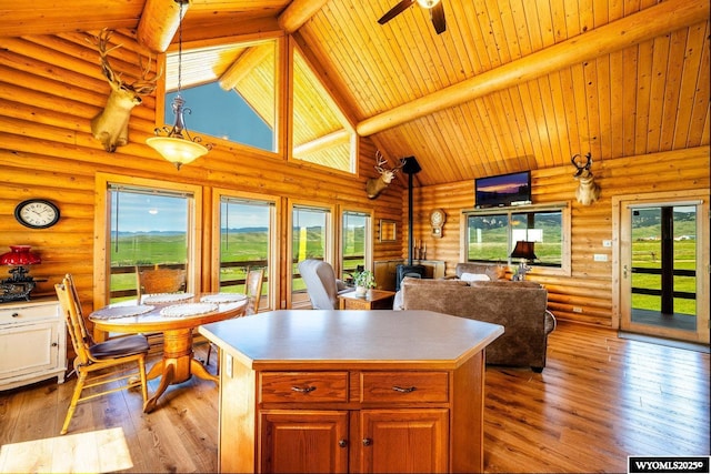 49 Cheyenne Rd, Banner, WY 82832 - kitchen with a wood stove, a center island, high vaulted ceiling, healthy amount of natural light, and hardwood / wood-style floors