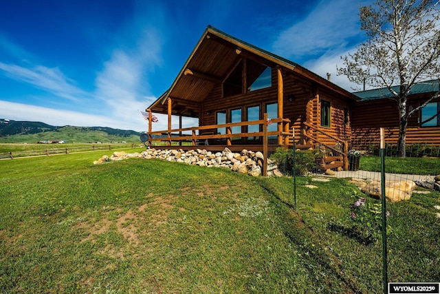 49 Cheyenne Rd, Banner, WY 82832 - rear view of house featuring a yard, log exterior, and a deck with mountain view