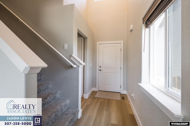 5845 Overlook Way, Mills, WY 82604 - hall with stairway, wood finished floors, and baseboards