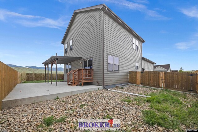 2511 Mercy Ln, Casper, WY 82609 - back of property with a patio area, a pergola, and a fenced backyard