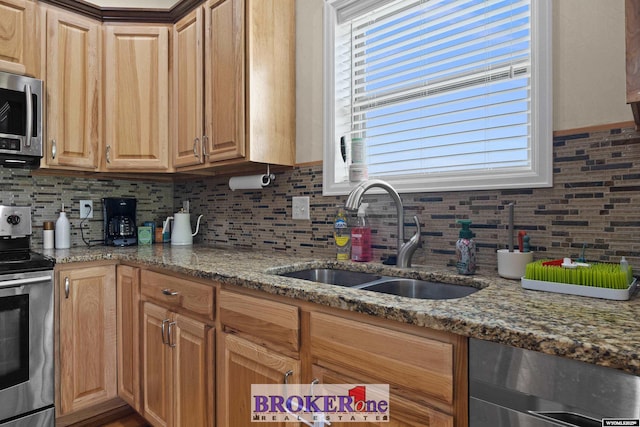 2511 Mercy Ln, Casper, WY 82609 - kitchen with stainless steel appliances, a sink, tasteful backsplash, and light stone countertops