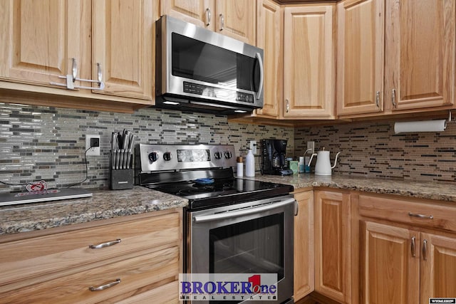 2511 Mercy Ln, Casper, WY 82609 - kitchen featuring appliances with stainless steel finishes, decorative backsplash, and stone counters