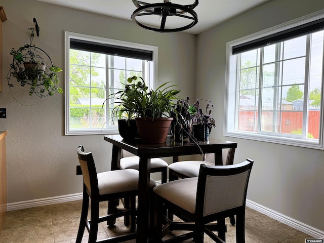 1216 Charles Ave, Worland, WY 82401 - dining area featuring healthy amount of natural light, baseboards, and light tile patterned floors