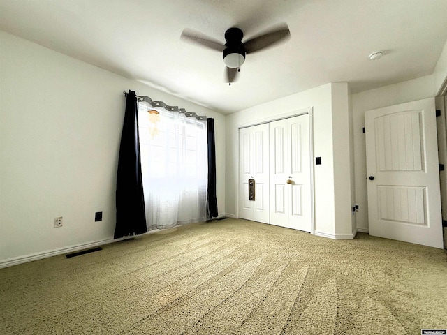 1216 Charles Ave, Worland, WY 82401 - unfurnished bedroom featuring carpet, baseboards, a closet, and ceiling fan