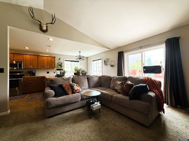 1216 Charles Ave, Worland, WY 82401 - living area featuring vaulted ceiling, recessed lighting, and dark colored carpet