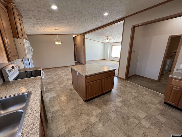1426 Pinecrest, Riverton, WY 82501 - kitchen with white appliances, brown cabinetry, baseboards, a textured ceiling, and a sink