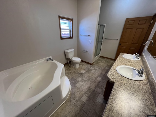 1426 Pinecrest, Riverton, WY 82501 - full bathroom with stone tile flooring, a bath, double vanity, toilet, and baseboards