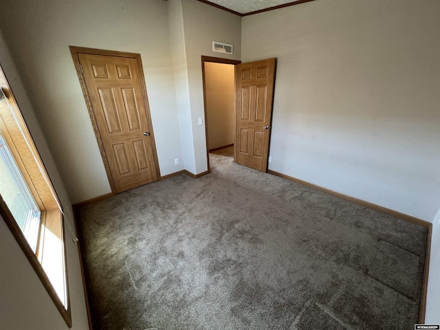 1426 Pinecrest, Riverton, WY 82501 - unfurnished bedroom with carpet floors, baseboards, and crown molding