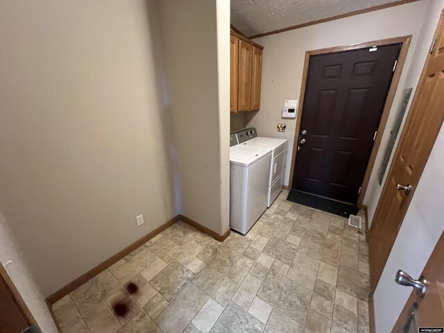 1426 Pinecrest, Riverton, WY 82501 - washroom featuring washer and dryer, cabinet space, baseboards, light stone finish flooring, and ornamental molding