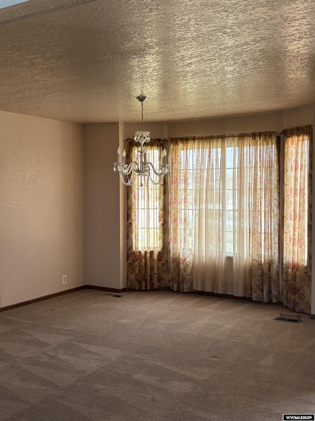 221 Rimrock Dr, Evanston, WY 82930 - spare room featuring a chandelier, carpet, a textured ceiling, and baseboards