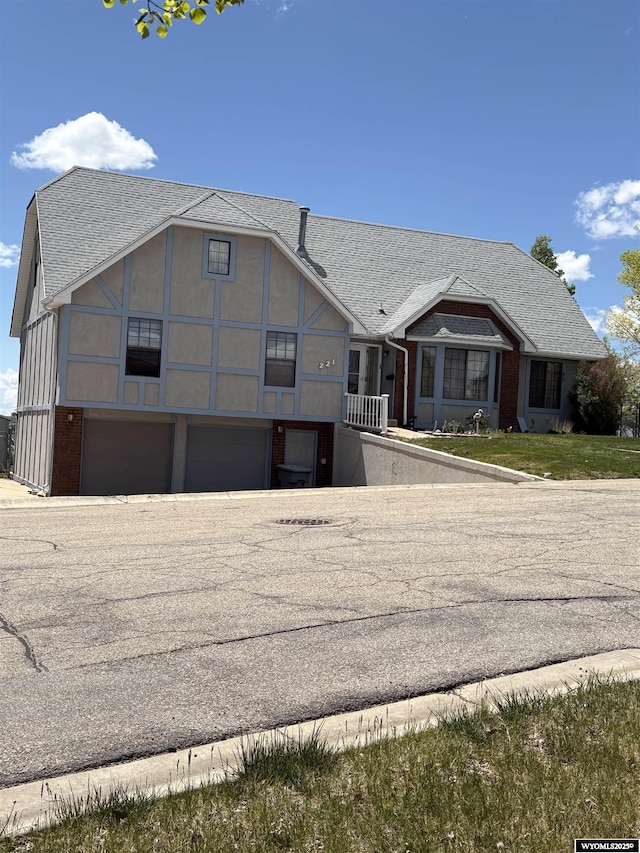 221 Rimrock Dr, Evanston, WY 82930 - view of front of house featuring an attached garage and roof with shingles