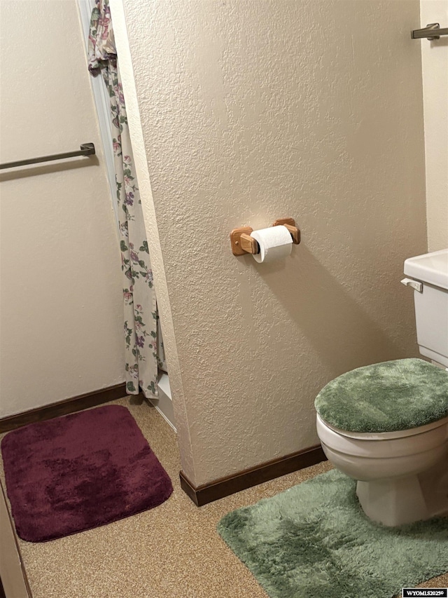 221 Rimrock Dr, Evanston, WY 82930 - full bathroom featuring toilet and a shower with shower curtain