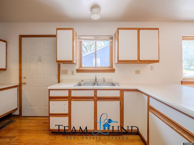 1235 S Durbin St, Casper, WY 82601 - kitchen with a sink, healthy amount of natural light, light countertops, and white cabinetry