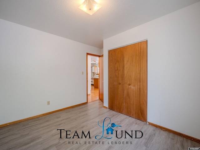 1235 S Durbin St, Casper, WY 82601 - unfurnished bedroom featuring light wood finished floors, a closet, and baseboards