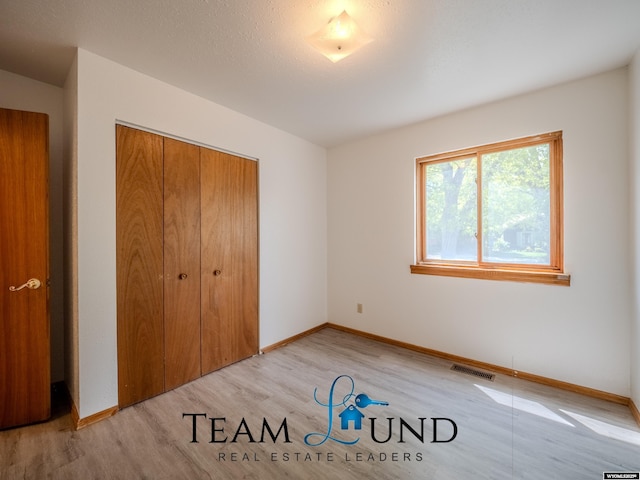 1235 S Durbin St, Casper, WY 82601 - unfurnished bedroom featuring light wood finished floors, a closet, and baseboards