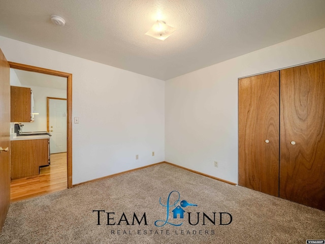 1235 S Durbin St, Casper, WY 82601 - unfurnished bedroom featuring light colored carpet, baseboards, and a closet