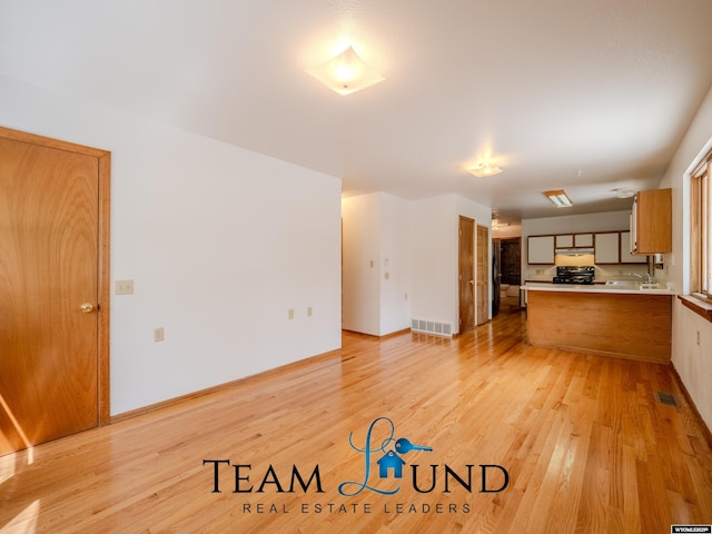 1235 S Durbin St, Casper, WY 82601 - unfurnished living room with light wood-type flooring and baseboards