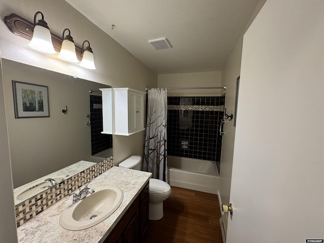 302 Clearview St, Saratoga, WY 82331 - full bathroom featuring wood finished floors, vanity, toilet, and shower / tub combo