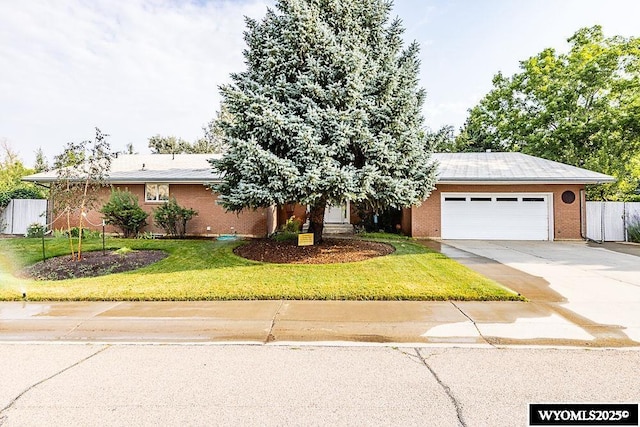 1823 Walnut St, Rock Springs, WY 82901 - view of front of house with brick siding, a garage, and driveway