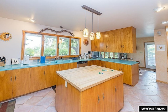 1823 Walnut St, Rock Springs, WY 82901 - kitchen with dishwasher, a center island, light tile patterned floors, and a peninsula