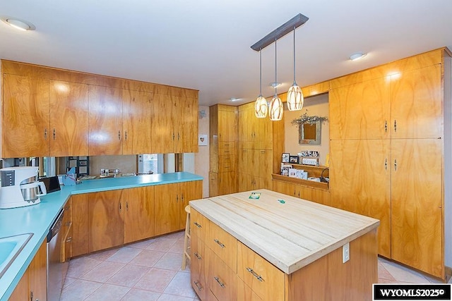 1823 Walnut St, Rock Springs, WY 82901 - kitchen featuring light tile patterned floors, a sink, light countertops, and a kitchen island
