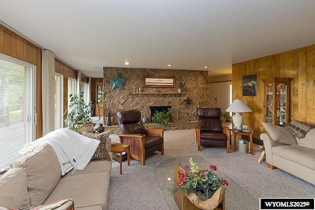 1823 Walnut St, Rock Springs, WY 82901 - carpeted living area with wooden walls and a stone fireplace