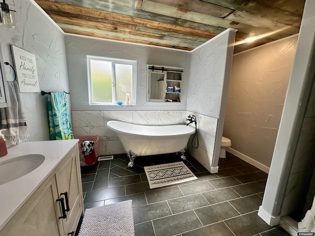 1023Pine Ave, Kemmerer, WY 83101 - bathroom featuring a freestanding tub, vanity, toilet, and tile patterned flooring