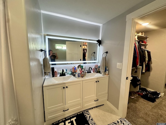 1023Pine Ave, Kemmerer, WY 83101 - full bathroom with double vanity, baseboards, and a walk in closet