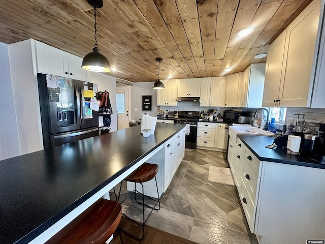 1023Pine Ave, Kemmerer, WY 83101 - kitchen with stainless steel appliances, dark countertops, wood ceiling, white cabinets, and a sink