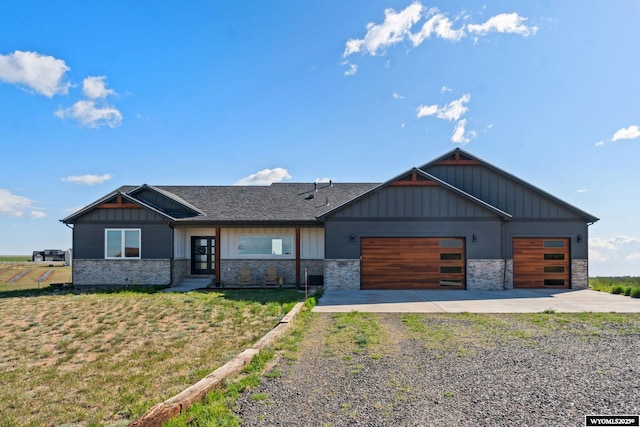 2352 Old Faithful Way, Cheyenne, WY 82009 - view of front of house featuring driveway, stone siding, a garage, and board and batten siding