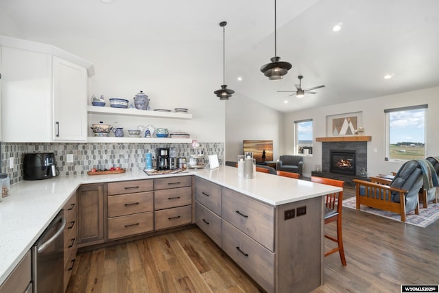 2352 Old Faithful Way, Cheyenne, WY 82009 - kitchen with ceiling fan, a peninsula, dark wood-style flooring, vaulted ceiling, and backsplash