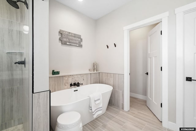 2352 Old Faithful Way, Cheyenne, WY 82009 - bathroom featuring a tile shower, a soaking tub, and tile walls